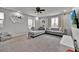Bright living room features neutral tones, stylish furniture, and a decorative wall mirror at 2849 Shelburne Way, St Cloud, FL 34772