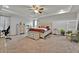 Spacious main bedroom with tray ceiling features neutral décor, large windows, and modern furniture at 2849 Shelburne Way, St Cloud, FL 34772