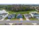 Aerial view of a house and neighborhood with a pond at 3027 Serendipity Way, Davenport, FL 33896
