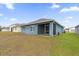 House exterior view with a screened porch and grassy yard at 3027 Serendipity Way, Davenport, FL 33896
