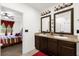 Spacious bathroom with double sinks and a view into bedroom at 3027 Serendipity Way, Davenport, FL 33896