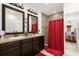 Double vanity bathroom with shower and red curtain at 3027 Serendipity Way, Davenport, FL 33896