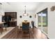 Dining area with table and chairs near kitchen and sliding glass doors at 3027 Serendipity Way, Davenport, FL 33896