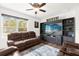 Relaxing living room with brown leather reclining furniture and large TV at 3027 Serendipity Way, Davenport, FL 33896
