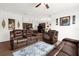 Open living room with kitchen view, featuring brown leather reclining sofas at 3027 Serendipity Way, Davenport, FL 33896