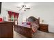 Main bedroom with king-size bed and wood dresser at 3027 Serendipity Way, Davenport, FL 33896