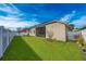 Landscaped backyard with grassy lawn, privacy fence and screened patio at 3040 Cardillino Way, Kissimmee, FL 34741