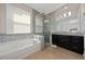 Large bathroom with soaking tub, walk-in shower, and dark wood vanity at 3040 Cardillino Way, Kissimmee, FL 34741