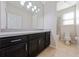 Bathroom boasts dark cabinetry, granite countertop and tiled floors at 3040 Cardillino Way, Kissimmee, FL 34741