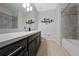 Clean bathroom with dark vanity and a bathtub at 3040 Cardillino Way, Kissimmee, FL 34741