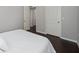 Simple bedroom with a white bedspread and hardwood floors at 3040 Cardillino Way, Kissimmee, FL 34741
