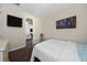 Bedroom with dark hardwood floors and a view of the living room at 3040 Cardillino Way, Kissimmee, FL 34741