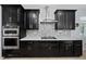 Stainless steel appliances and dark wood cabinetry in this gourmet kitchen at 3040 Cardillino Way, Kissimmee, FL 34741