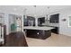 Modern kitchen with large island, stainless steel appliances, and dark wood cabinetry at 3040 Cardillino Way, Kissimmee, FL 34741