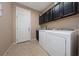 Laundry room with washer, dryer, and cabinets at 3040 Cardillino Way, Kissimmee, FL 34741