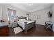 Spacious Primary bedroom with hardwood floors and a large TV at 3040 Cardillino Way, Kissimmee, FL 34741