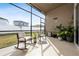 Spacious screened porch with rocking chairs, plants and screened enclosure at 3040 Cardillino Way, Kissimmee, FL 34741