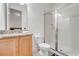 Bathroom featuring a glass-enclosed shower, toilet, and wood vanity at 350 Pendant Ct, Kissimmee, FL 34747