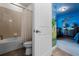 Bathroom with shower/tub combination, and doorway into bedroom with themed wall art at 350 Pendant Ct, Kissimmee, FL 34747