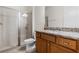 Bright bathroom featuring granite countertops, a vanity, and a glass door shower at 350 Pendant Ct, Kissimmee, FL 34747