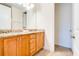 Bathroom featuring double vanity with granite counters and wood cabinets at 350 Pendant Ct, Kissimmee, FL 34747