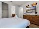 Bedroom with flat screen TV and ensuite bathroom featuring a comfortable bed and dresser at 350 Pendant Ct, Kissimmee, FL 34747