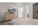 Bedroom featuring flat screen TV and dresser, and a bed with light patterned comforter at 350 Pendant Ct, Kissimmee, FL 34747