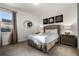 Cozy bedroom with a queen bed, and a round mirror on the wall at 350 Pendant Ct, Kissimmee, FL 34747