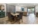 Open dining area features modern chairs, a table, and opens to a large window and living area at 350 Pendant Ct, Kissimmee, FL 34747
