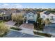 Two-story home boasts lush landscaping, a paver driveway, turquoise shutters, and a two-car garage at 350 Pendant Ct, Kissimmee, FL 34747