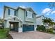 Charming two-story home featuring a brick driveway, teal shutters and a matching two-car garage door at 350 Pendant Ct, Kissimmee, FL 34747