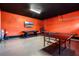 Spacious game room with a ping pong table, air hockey, and an accent wall at 350 Pendant Ct, Kissimmee, FL 34747