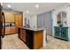 Kitchen island with a sink and dishwasher sits in front of patterned curtains and a small dining table at 350 Pendant Ct, Kissimmee, FL 34747