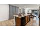 Kitchen island with granite countertops and sink, with an open view into a living room and dining area at 350 Pendant Ct, Kissimmee, FL 34747