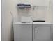A conveniently located laundry room features a modern washer, dryer, and shelving for storage at 350 Pendant Ct, Kissimmee, FL 34747