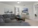 Relaxing living room with neutral decor, a large sectional sofa, and a flat-screen television at 350 Pendant Ct, Kissimmee, FL 34747