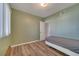 Bedroom featuring green walls, wood-look laminate flooring, closet and natural light at 4201 Park Lake St, Orlando, FL 32803