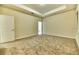Well-lit bedroom with neutral carpeting and access to a bathroom at 4310 Seven Canyons Dr, Kissimmee, FL 34746
