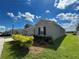 Side view of gray house with windows and landscaping at 4310 Seven Canyons Dr, Kissimmee, FL 34746