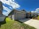 Two-car garage with gray exterior and light fixtures at 4310 Seven Canyons Dr, Kissimmee, FL 34746