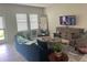 Living room with blue sofa, TV, and wooden cabinet at 4310 Seven Canyons Dr, Kissimmee, FL 34746