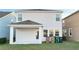 Backyard patio with covered space and a view of the well-maintained lawn and the house's rear exterior at 4571 Tribute Trl, Kissimmee, FL 34746