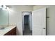 Bathroom vanity leading to a walk-in closet at 4571 Tribute Trl, Kissimmee, FL 34746