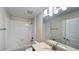 Bathroom features a tiled shower-tub, toilet, vanity with a sink and mirror above it at 4571 Tribute Trl, Kissimmee, FL 34746