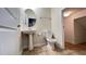 Well-lit half bathroom features modern fixtures, a pedestal sink, and tile floors at 4571 Tribute Trl, Kissimmee, FL 34746
