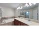 Large mirror reflecting tub and walk-in shower in neutral tiled bathroom at 4571 Tribute Trl, Kissimmee, FL 34746