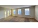 Bright bedroom with three windows and neutral carpeting at 4571 Tribute Trl, Kissimmee, FL 34746