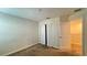 A small, carpeted bedroom with a closet with bi-fold doors at 4571 Tribute Trl, Kissimmee, FL 34746