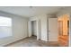 This is a bedroom with neutral walls and carpet, as well as a closet with folding doors at 4571 Tribute Trl, Kissimmee, FL 34746