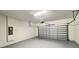 Spacious garage with epoxy flooring, overhead lighting, and ample room for parking at 4571 Tribute Trl, Kissimmee, FL 34746